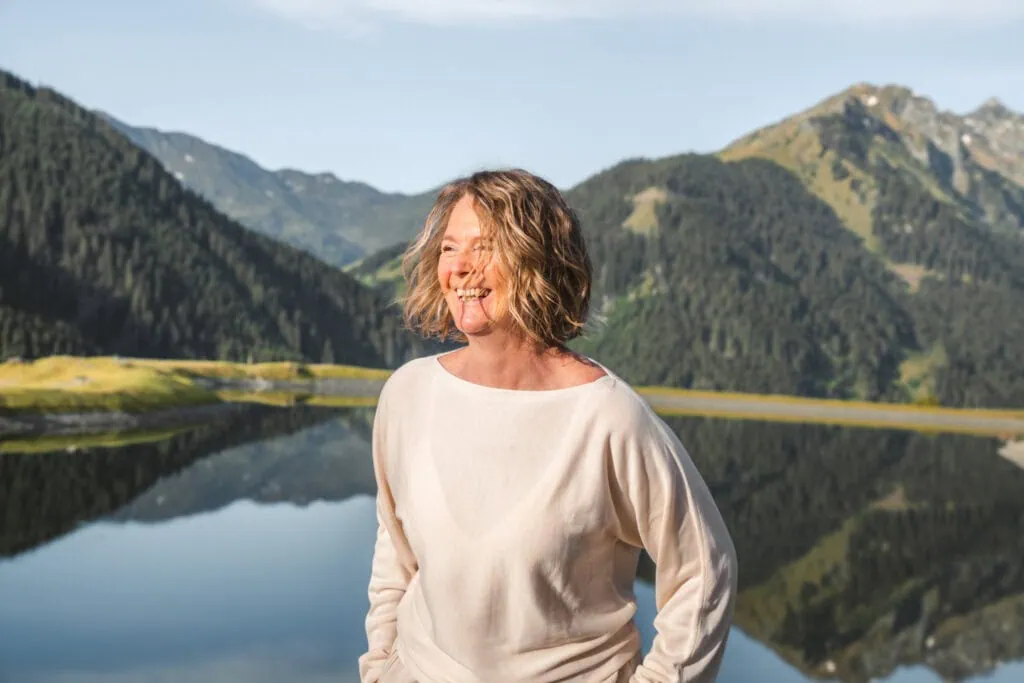 Freie Redner Österreich im Freien vor malerischer Bergkulisse mit See, lächelnd und entspannt, für Hochzeiten und Veranstaltungen.